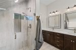 Large tile and glass shower with bench in Master suite